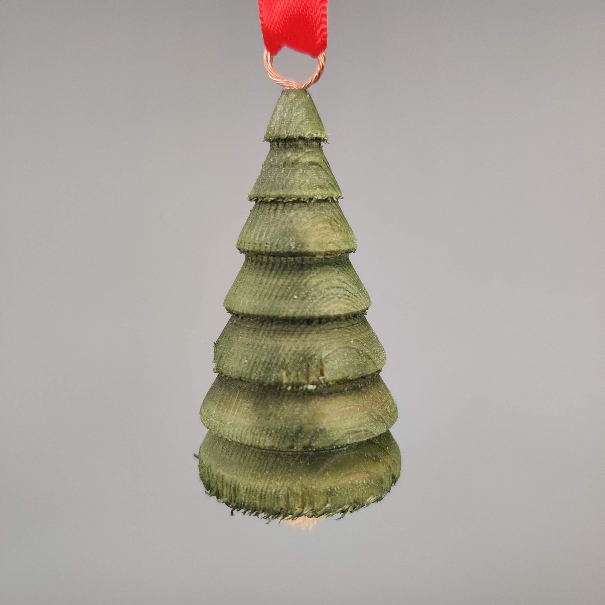 Green Wooden Christmas tree ornament on a gray background