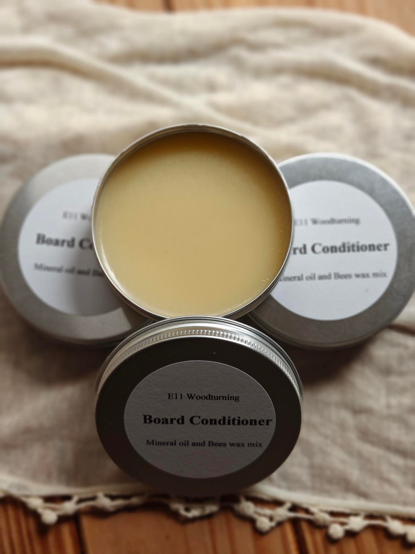 three tins board conditioner one open