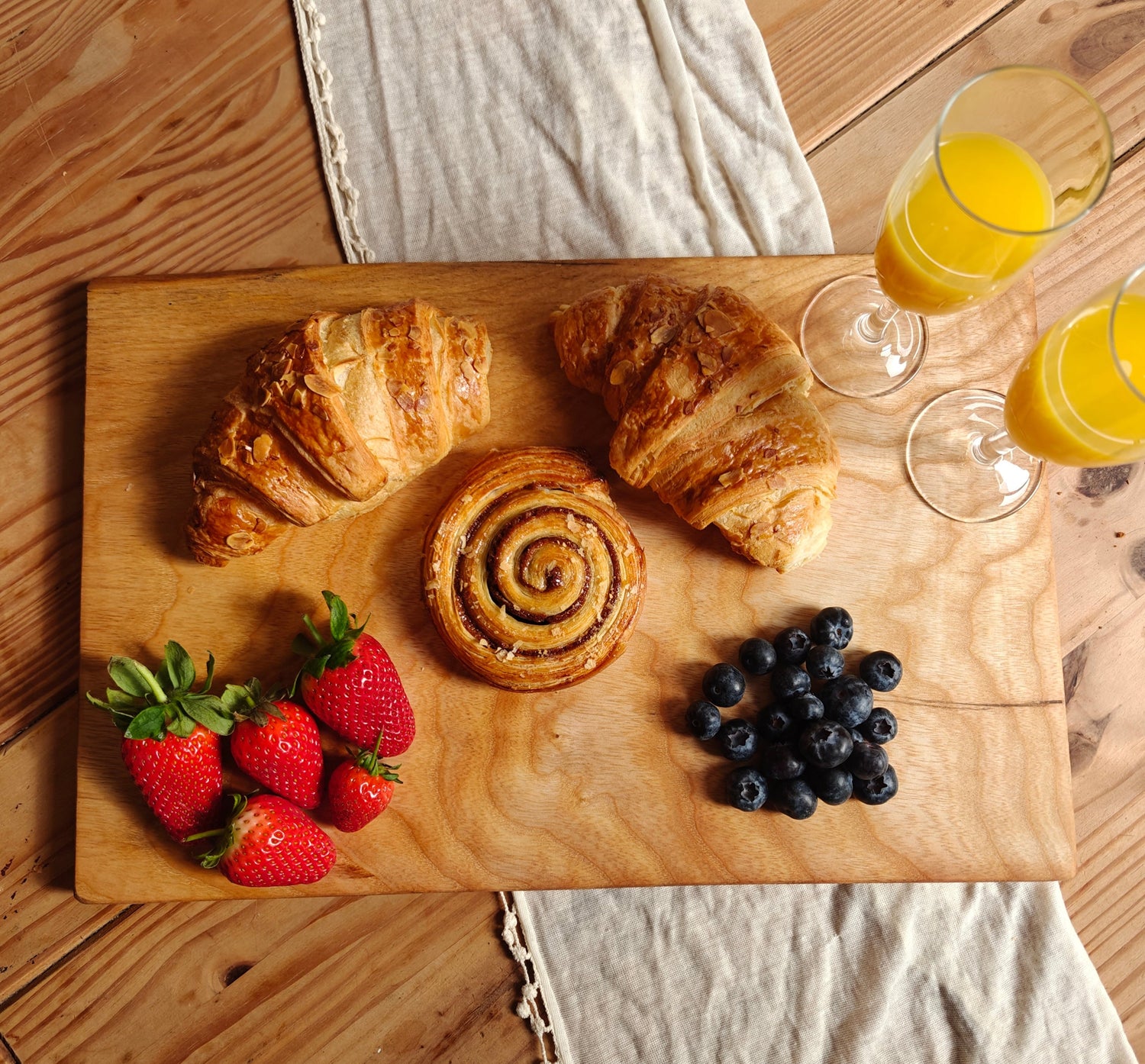 Large Ash Serving Board showing it layed out with two glasses of orange juice croissants and fruit