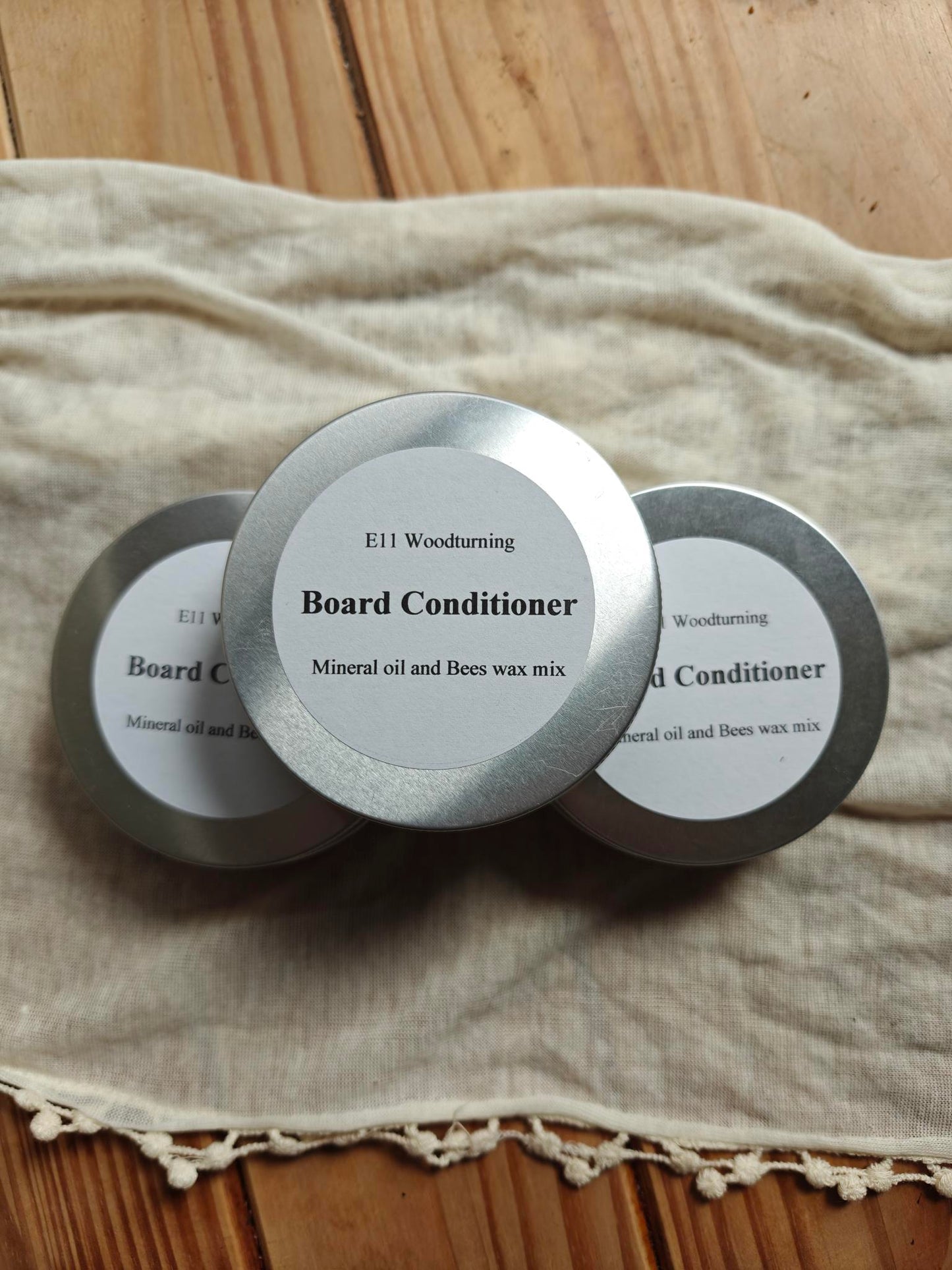 Three tins of board conditioner 