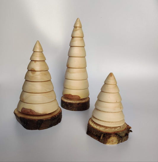 Three wooden Christmas tree ornaments on a white background