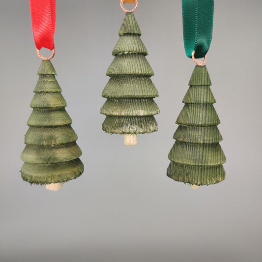Three green tree-shaped ornaments with ribbons on a gray background